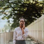 Young woman walking in an urban area while making a phone call looking focused